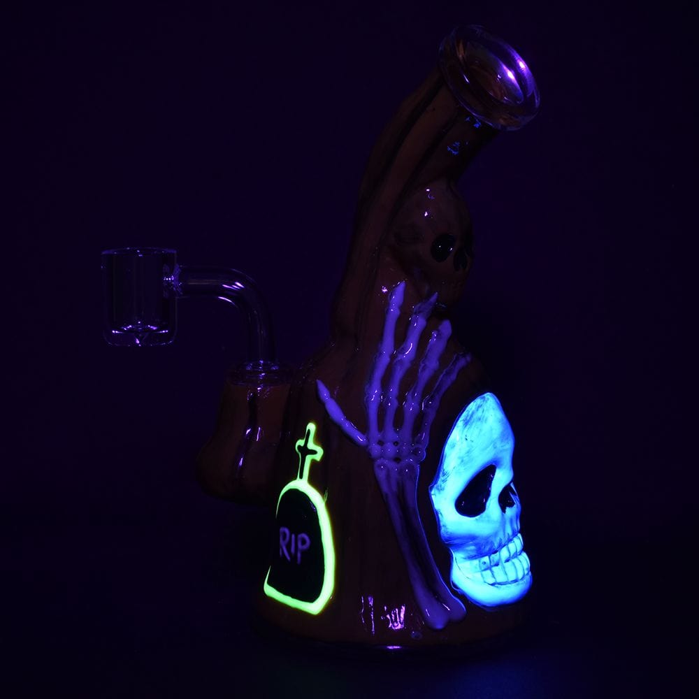 A moody, low-angle shot features the Haunted Gourd Enamel on Glass Dab Rig dramatically lit against a dark background.