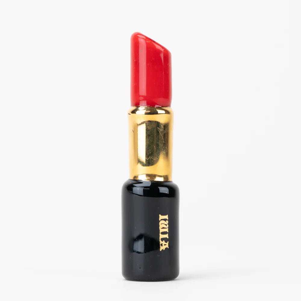 A close-up studio shot of the SakiBomb Purple Lipstick Chillum, resembling a purple lipstick tube.