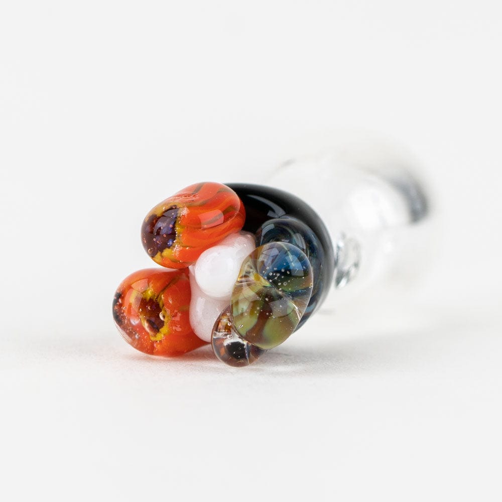 A close-up, angled view of the Coral PuffCo Peak Pro Glass Ball Cap, showing its rounded shape and reflective surface.