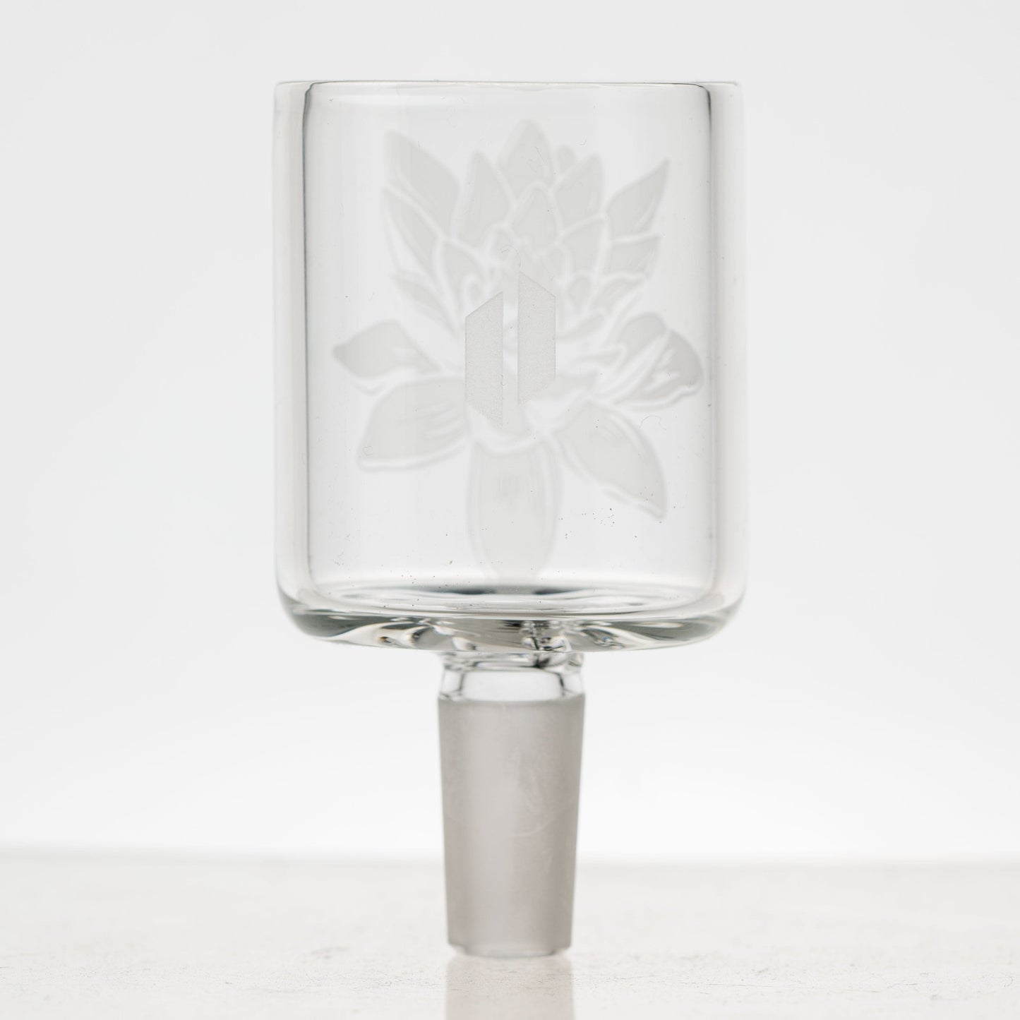 Front view of the Frosty Lotus Puffco Proxy Glass Attachment, showcasing its clear glass construction and intricate lotus-flower design.