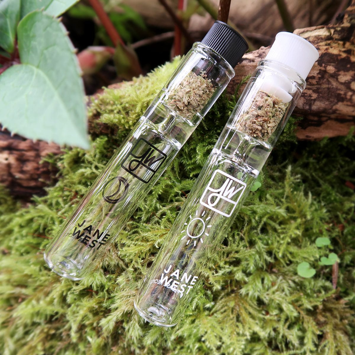 A close-up shot of the Day & Night Travel Pipe Set, nestled amongst vibrant green moss with soft, natural lighting.