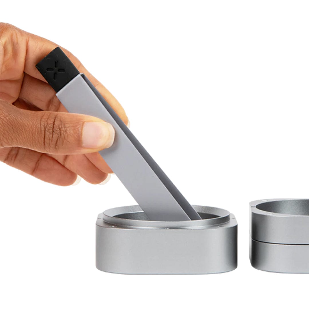 A close-up shows the Pax Prep Tongs gently lifting a lid from a silver container, highlighting their sleek, metallic design.