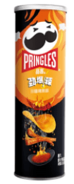 A close-up, angled shot of Pringles - Spicy Strips, showcasing the snack’s cylindrical packaging with bold red accents.