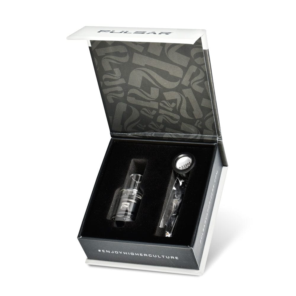 The APX Wax V3 Triple Quartz & Barb Coil atomizer tank is displayed inside its open box against a black background.