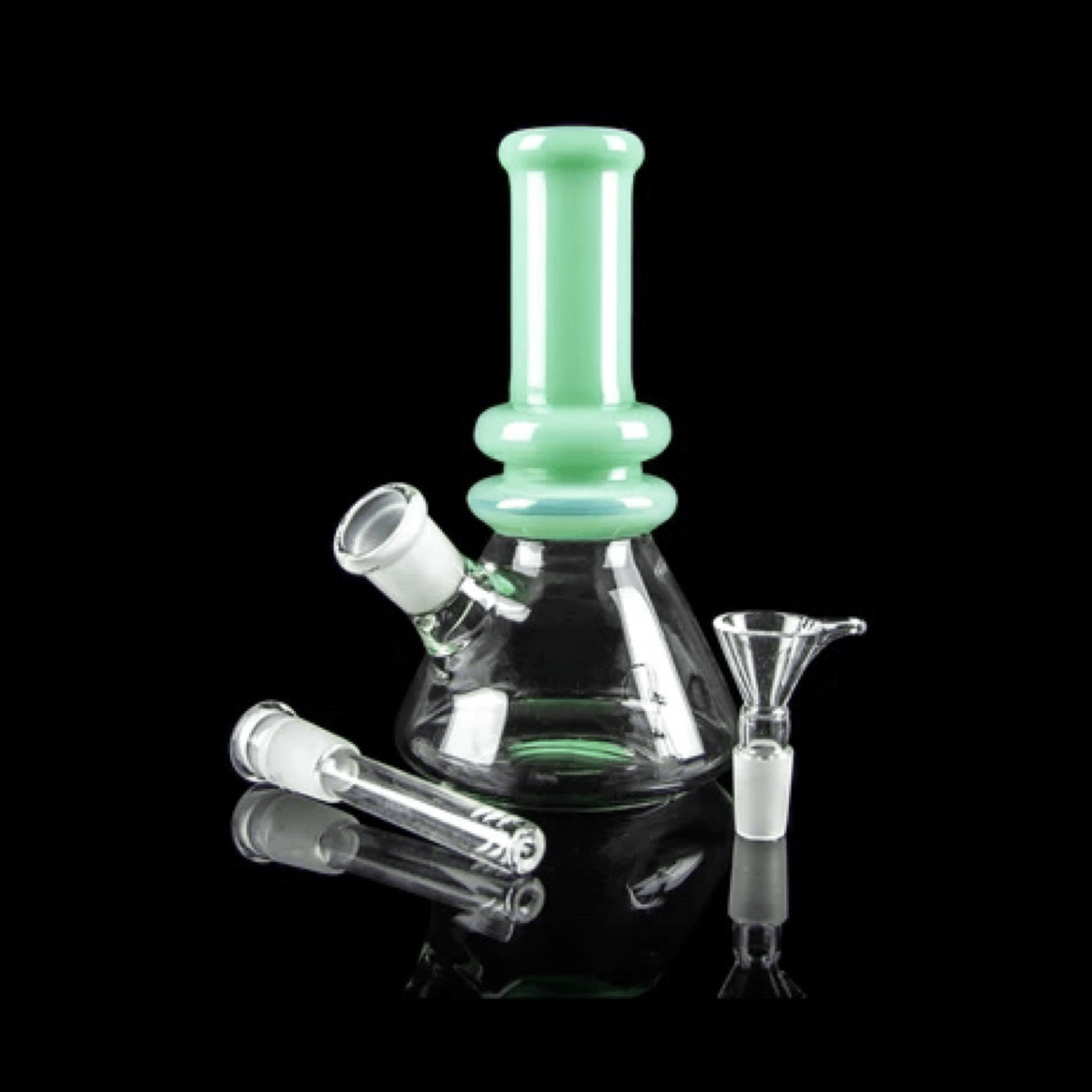 Front view of the Minty Bong, a clear glass water pipe with a wide base and visible joint, reflected on a dark surface.
