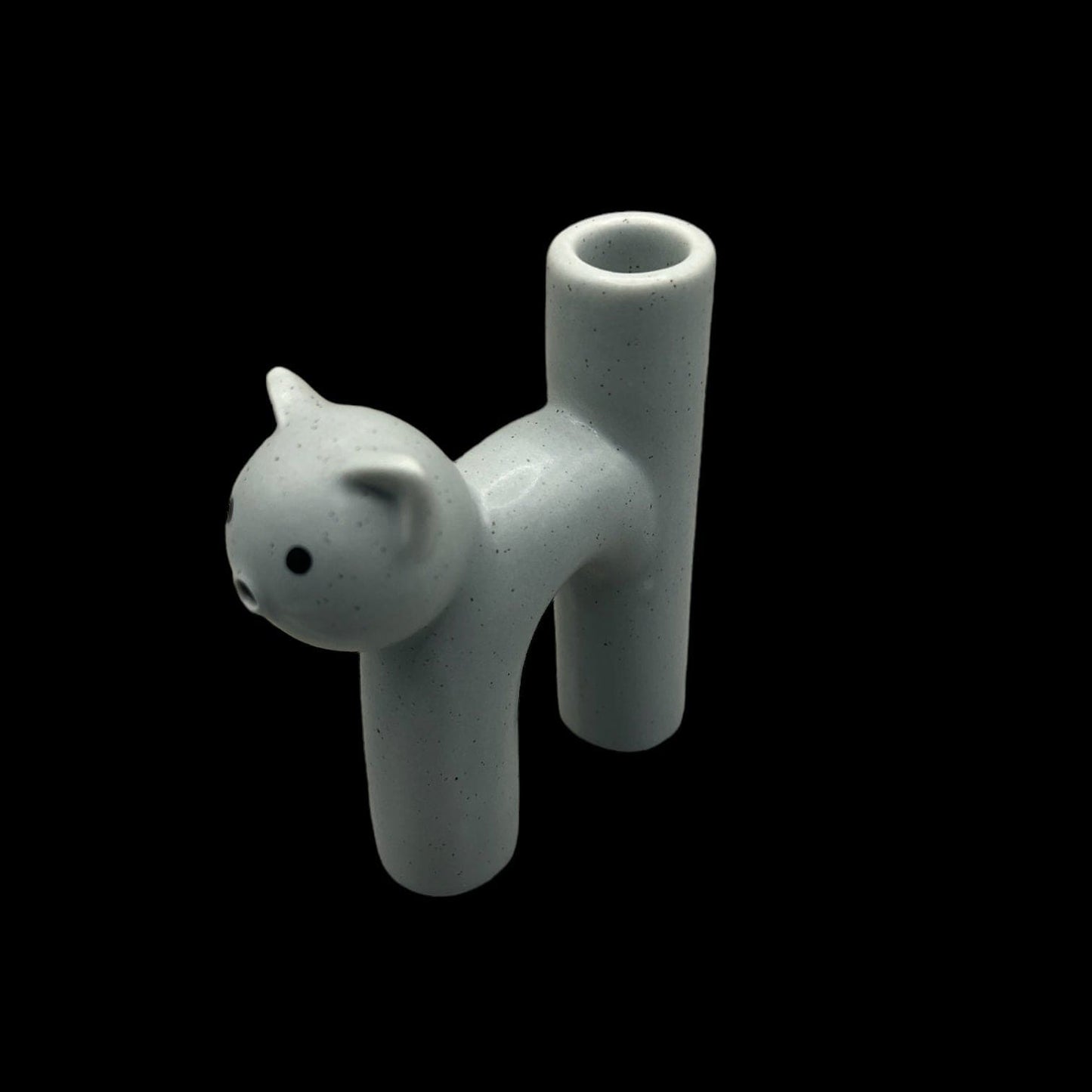 A slightly angled, overhead shot of the Kitty Cat Pipe & Ashtray, showcasing its smooth, sculpted form on a dark surface.