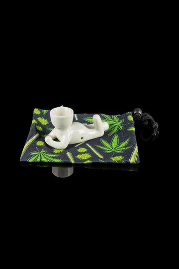 The Pot Head Pipe is shown in a close-up, resting on a patterned black and green pouch.