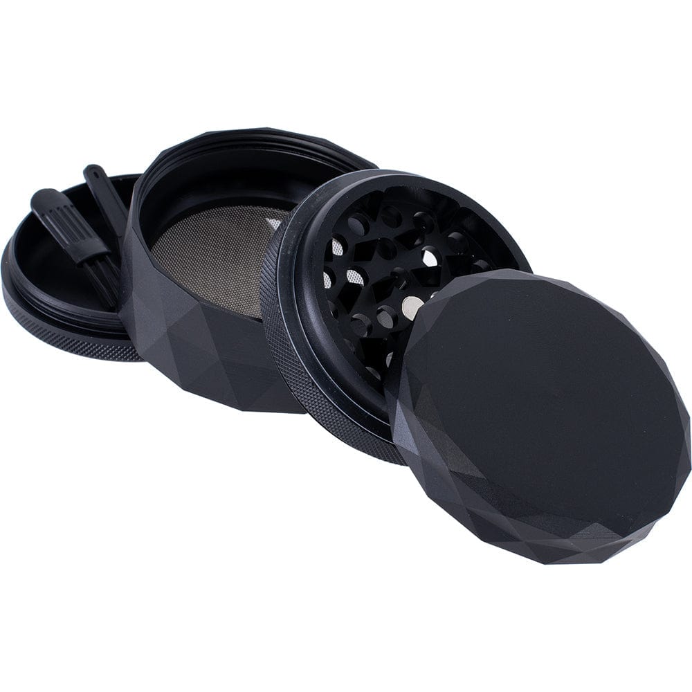 A close-up, angled view of the Four Piece Grinder, showcasing its four sections slightly separated on a neutral background.