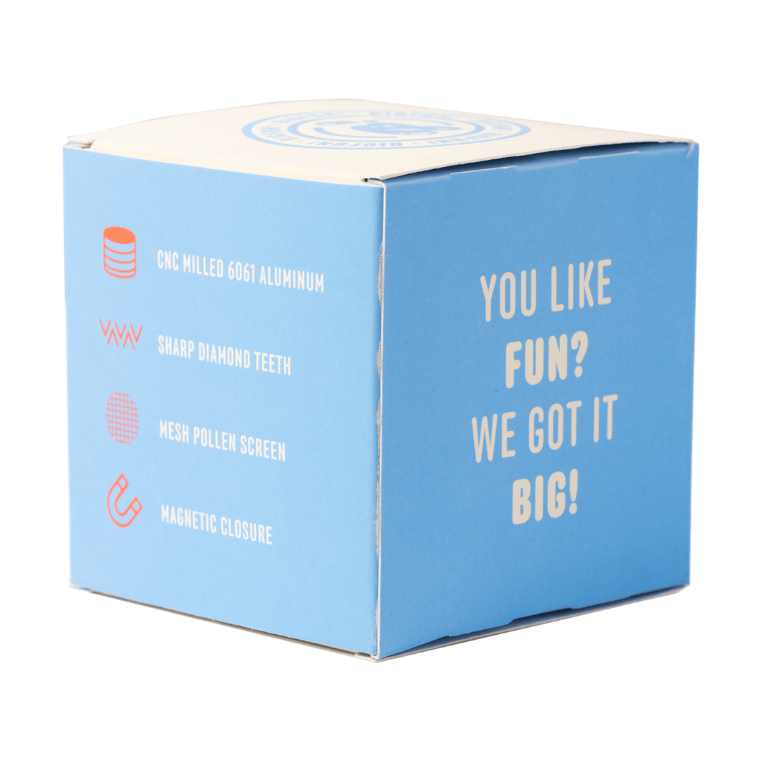 A close-up, angled view of the BIGFUN! XL Grinders, showcasing its metallic finish and circular design against a dark backdrop.