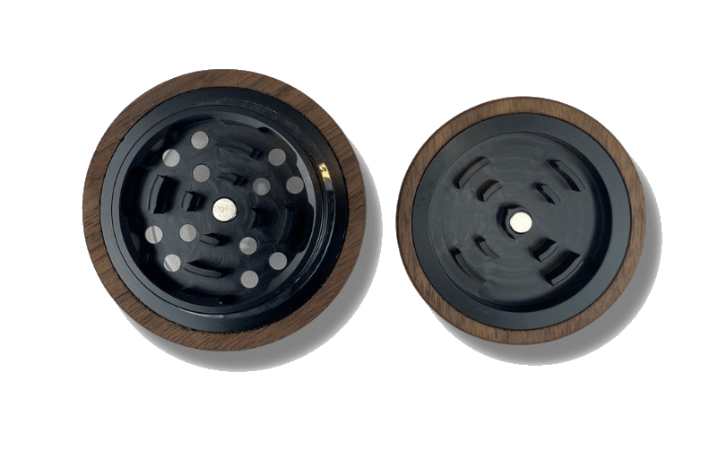 Overhead view of The Bzz Glass Grinder, showcasing its circular design and metallic grinding teeth against a plain white background.