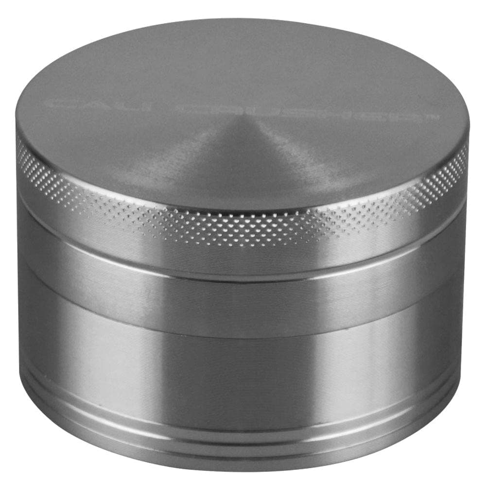 A close-up, angled view of the Cali Crusher O.G. Grinder, a metallic 4-piece grinder with a smooth, cylindrical design.