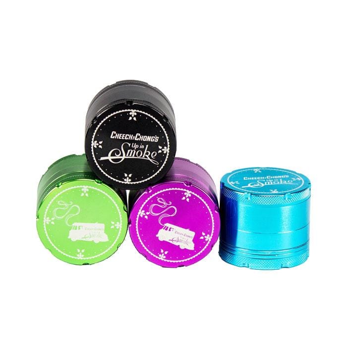 Close-up of the Up In Smoke 50mm 4-Piece Grinder, showcasing the metallic finish and circular design from a slightly angled, top-down view.