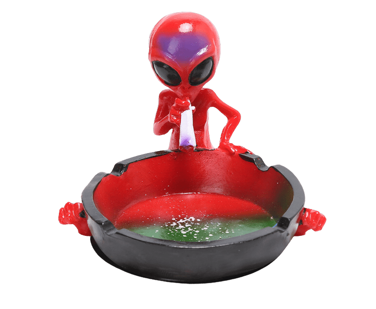 A close-up shows the Ceramic Smoking Alien Ashtray Ash Catcher with a glossy finish, angled from above against a plain white background.