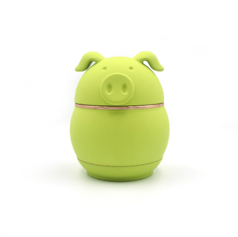 Front view of the Cute Animal Aluminum Grinder, a small, green grinder shaped like an animal head against a plain white background.