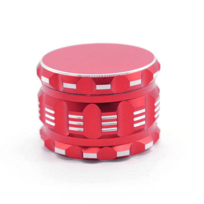 A slightly angled, close-up view of the 4 Piece Aluminum Drum Shape Grinder, showcasing its multi-tiered metallic finish.