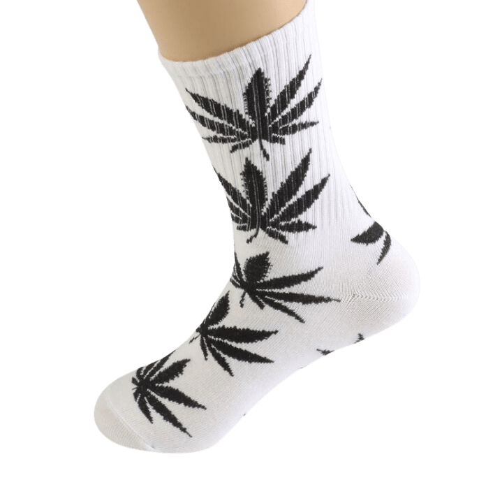 A low-angle shot displays the Cannabis Weed Marijuana Leaf Unisex Hip Hop Street Fashion Comfortable Cotton Crew Socks on a foot.