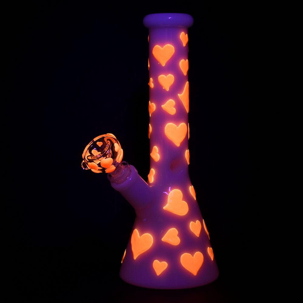 Front view of the 10" Valentines Day Heart Glow In The Dark Beaker Water Pipe, showcasing heart patterns on its purple glass body.