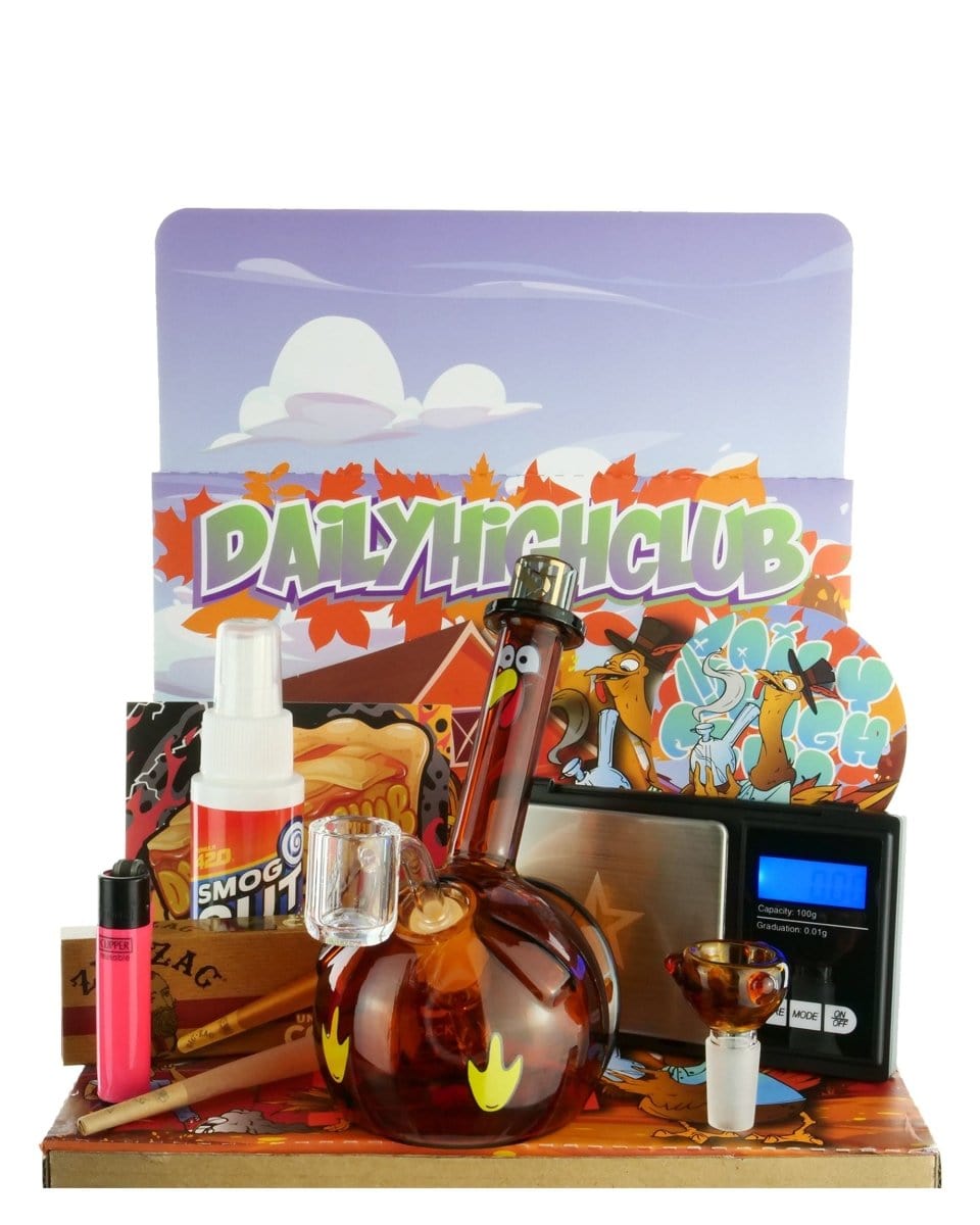 A high-angle view of the “Have A Happy Danksgiving!” Smoking Box surrounded by accessories on a dark surface.