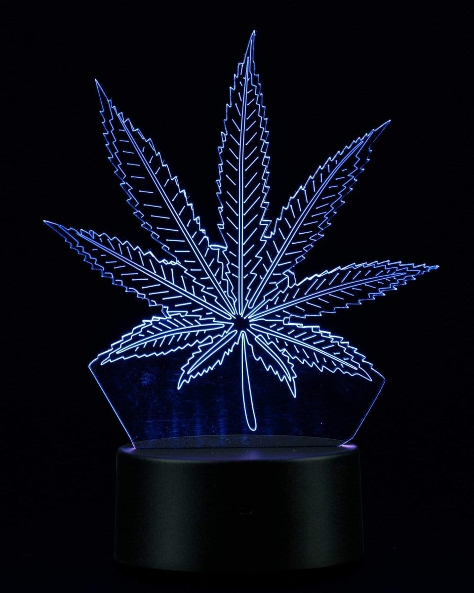 A low-angle view of the illuminated 3D Cannabis Leaf Lamp, showcasing its detailed leaf shape against a dark background.