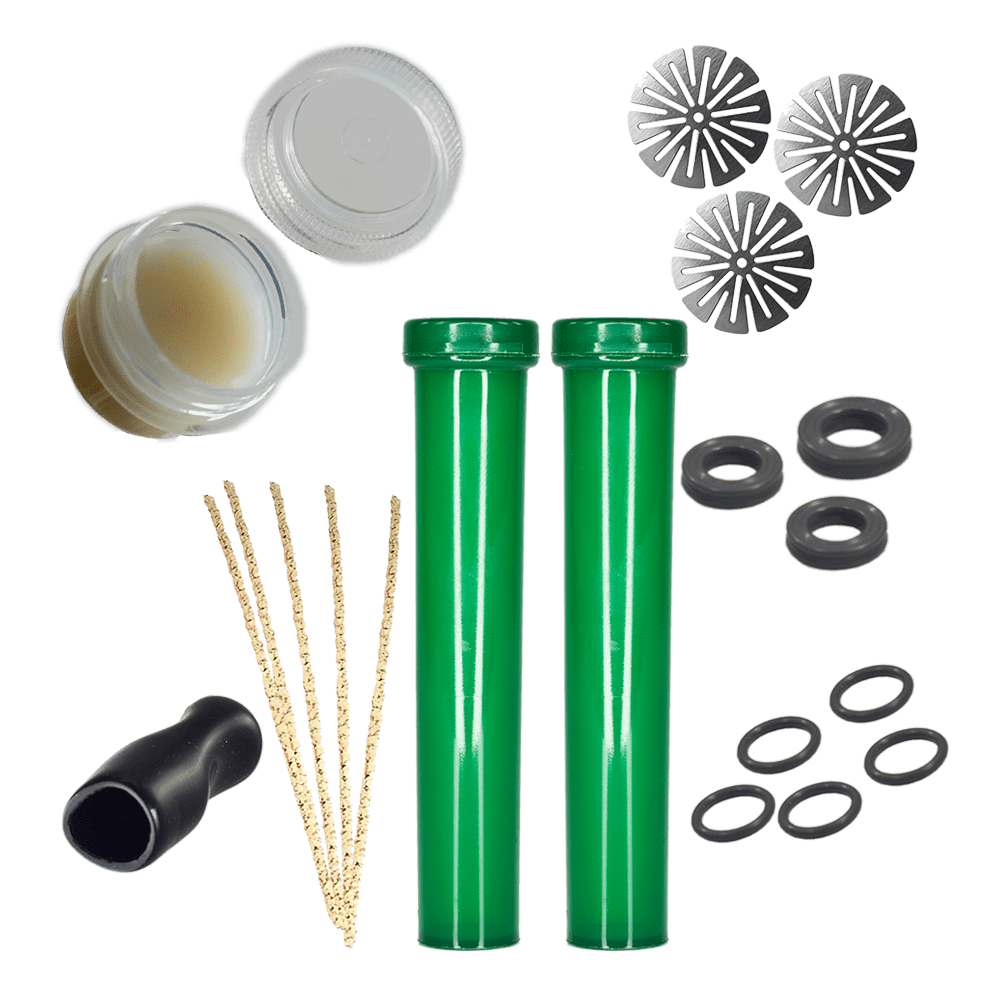 Overhead view of the DynaKit: Basic components arranged on a white surface, including small glass vials, metal screens, and rubber o-rings.