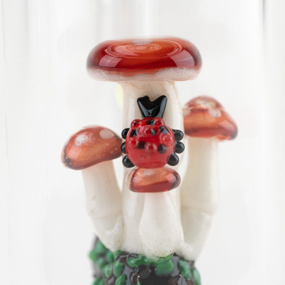A front view of the Cosmic Mushrooms Mini Rig, featuring sculpted glass resembling mushroom caps and a textured green base.