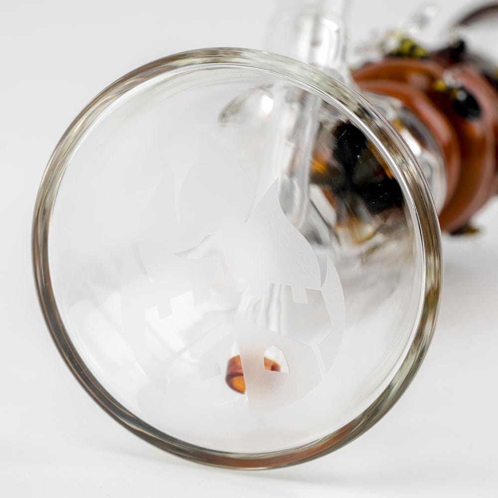 A close-up, angled view of the Save the Bee's Beaker, showing a clear glass construction with a visible joint detail.