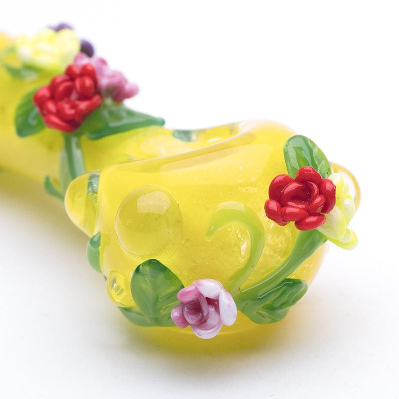Close-up of the Rainbow Garden Mini Spoon, showing delicate floral details wrapping around the curved glass pipe.