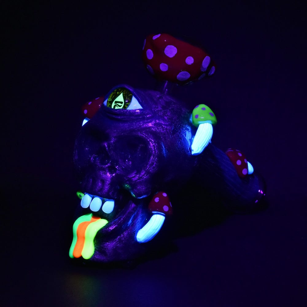 A close-up shot of the Pulsar Rainbow Puking Skull Bubbler Pipe, featuring a colorful, mushroom-like design against a black background.