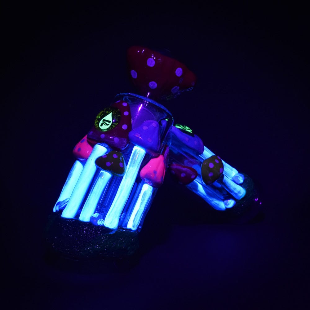 A vibrant, angled view of the Pulsar Shroom Forest Bubbler Pipe, featuring a fantastical mushroom design with glowing blue accents.