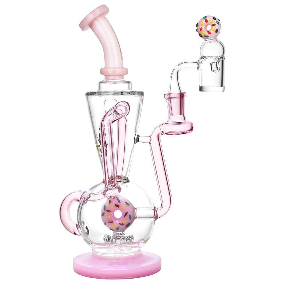 A three-quarter view of the Pulsar Delectable Donut Recycler Dab Rig Kit, featuring a pink glass base and a donut-shaped accent.
