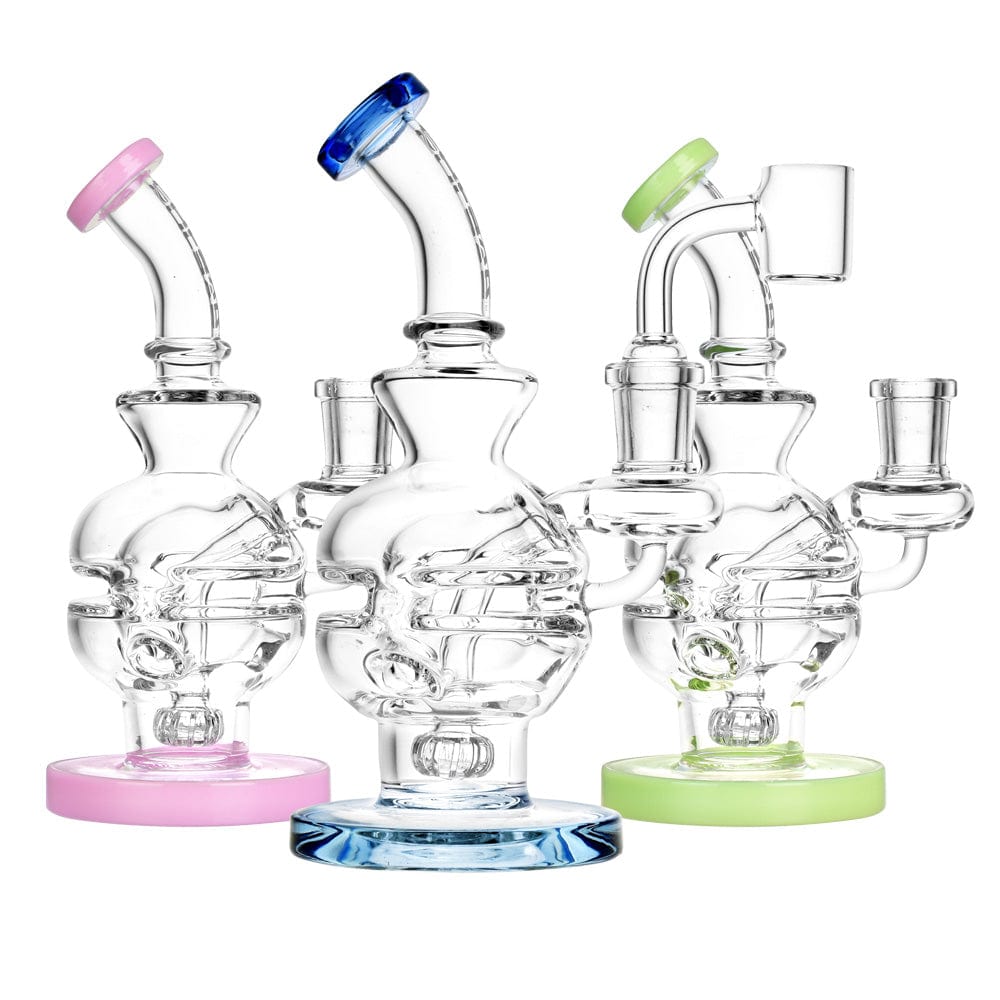 A studio shot of the 7-inch Pulsar Mini Egg Dab Rig Recycler, showing multiple color variations arranged in a row against a white background.