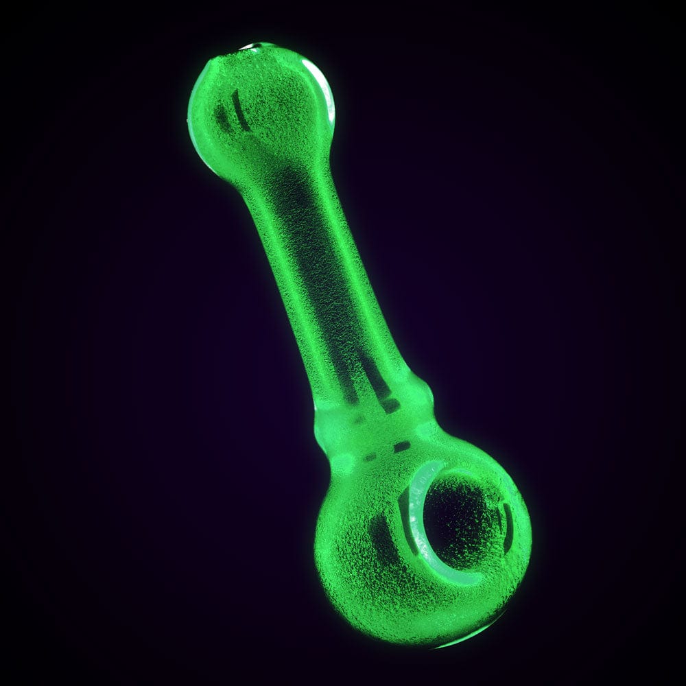 A brightly lit, front view of the Glow in Dark Color Spoon Pipe - 4.25", showcasing its curved design and vibrant green hue.