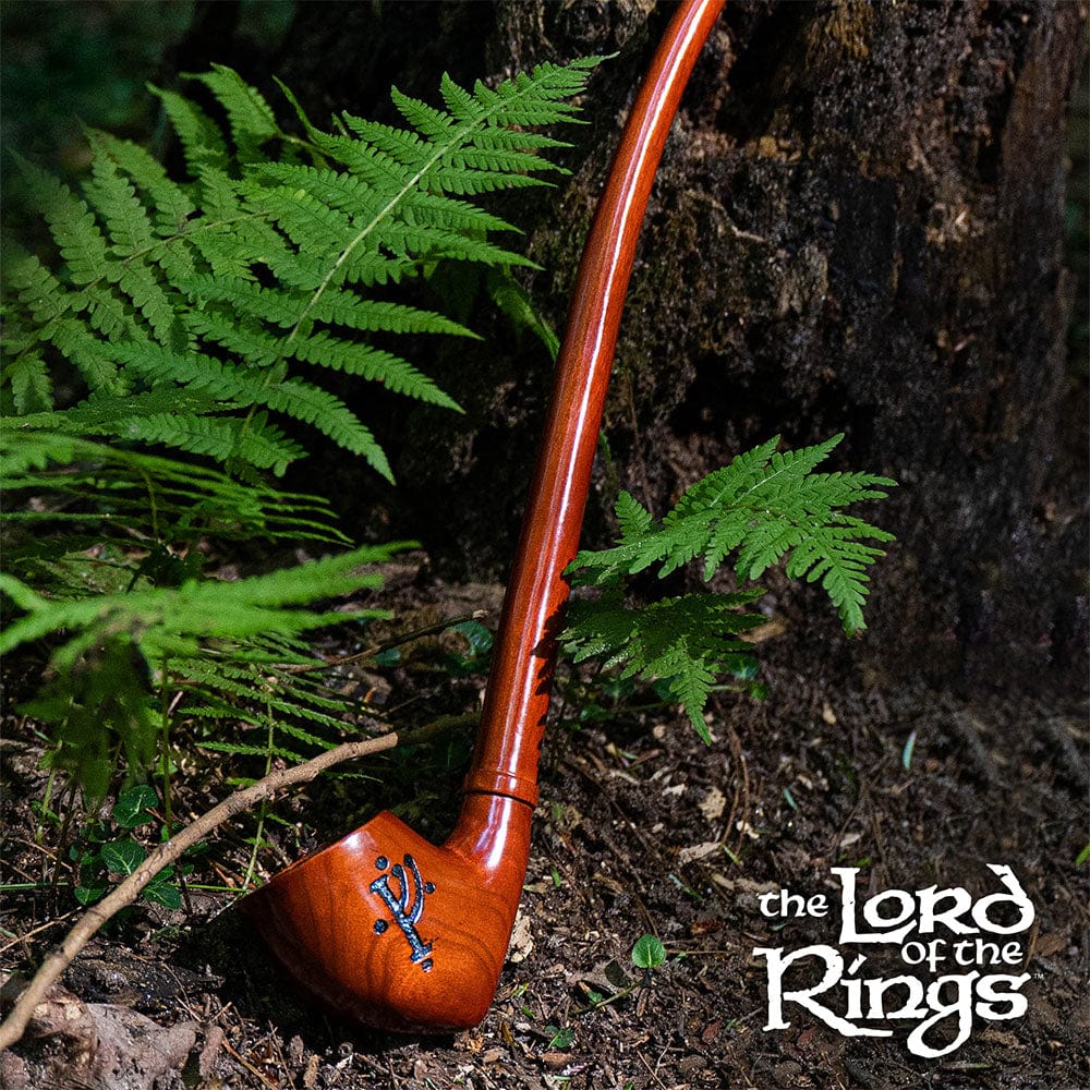 A close-up, angled view of the Pulsar Shire Pipes GANDALF Smoking Pipe, nestled amongst green ferns.