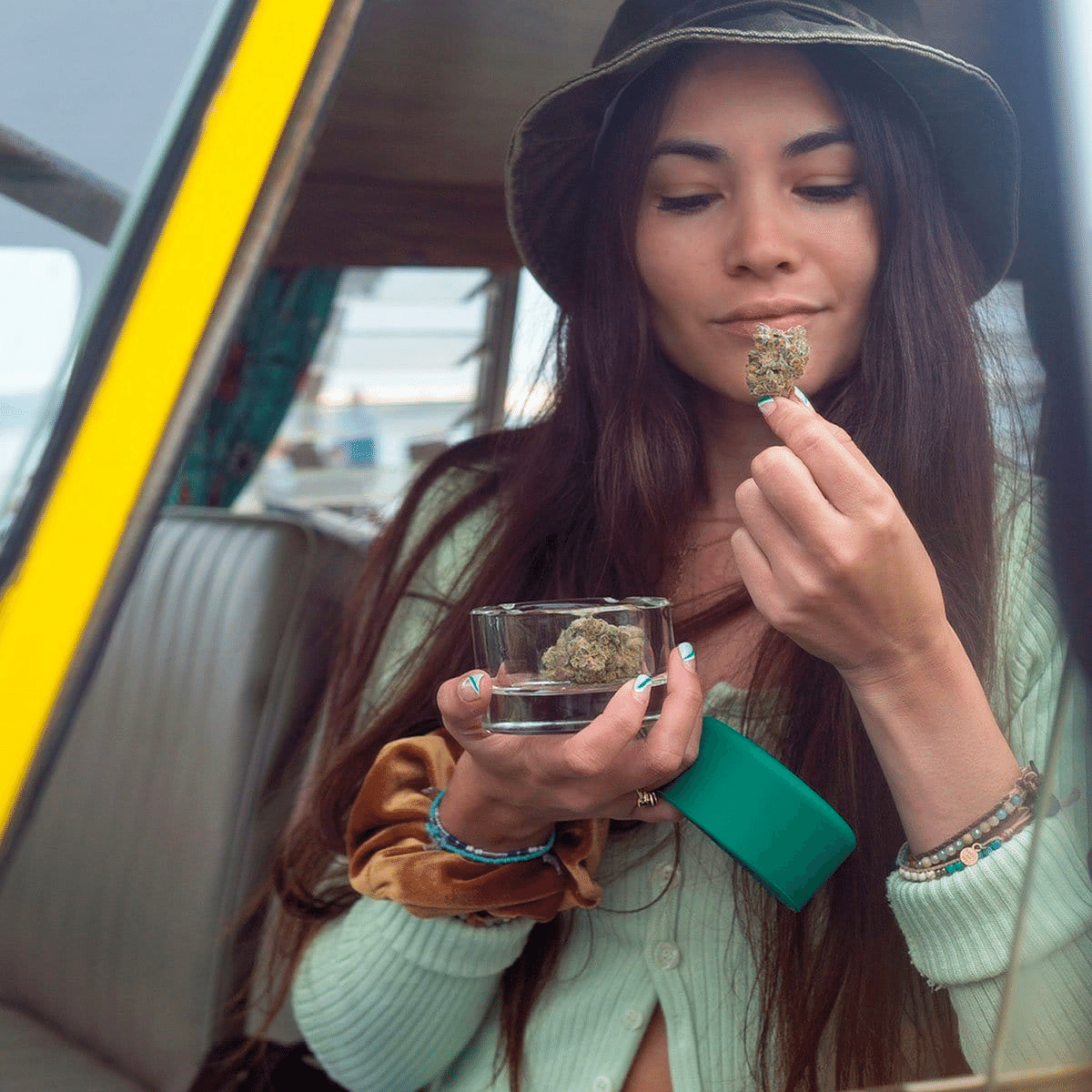 A close-up, low-angle view shows the Ashtray held delicately in a person’s hands against a muted, out-of-focus background.