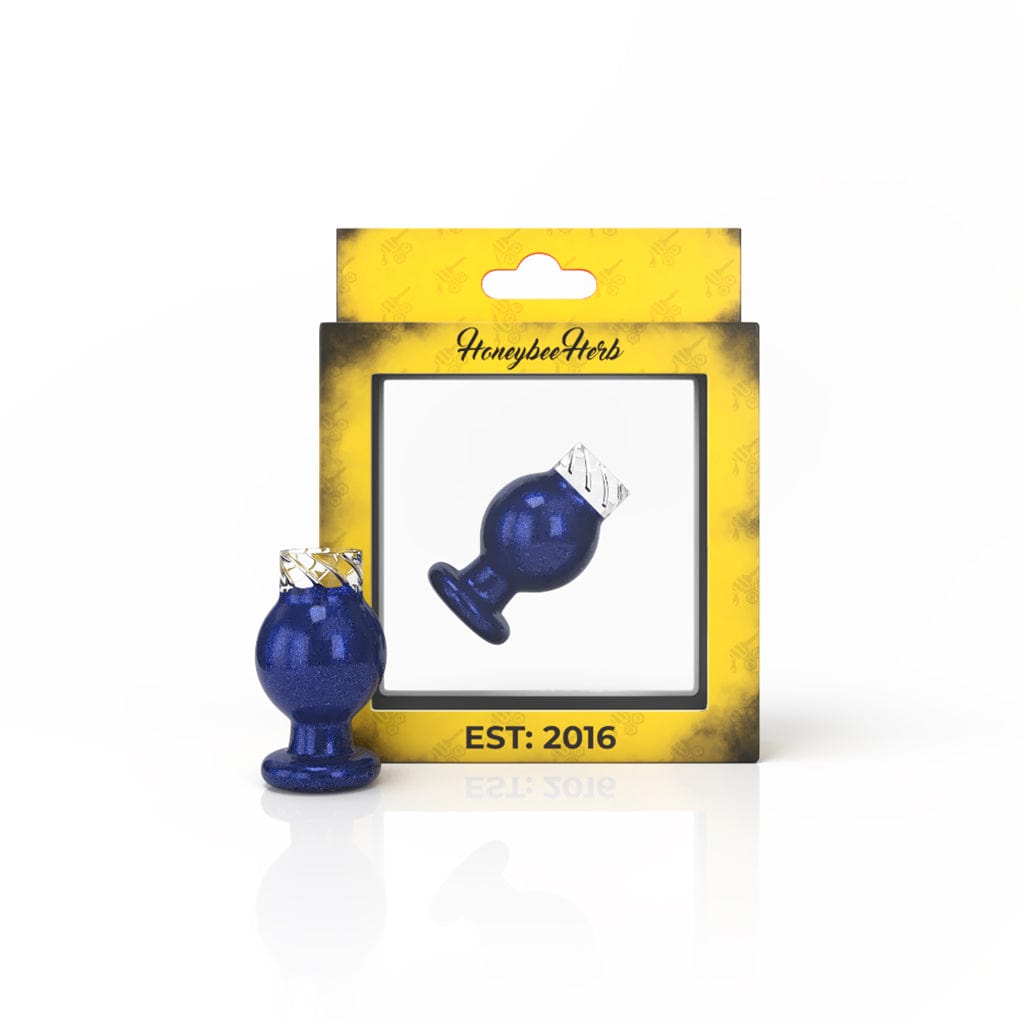 Close-up view of the Vortex Bubble Carb Cap, a small, rounded glass piece reflecting light on a dark surface.