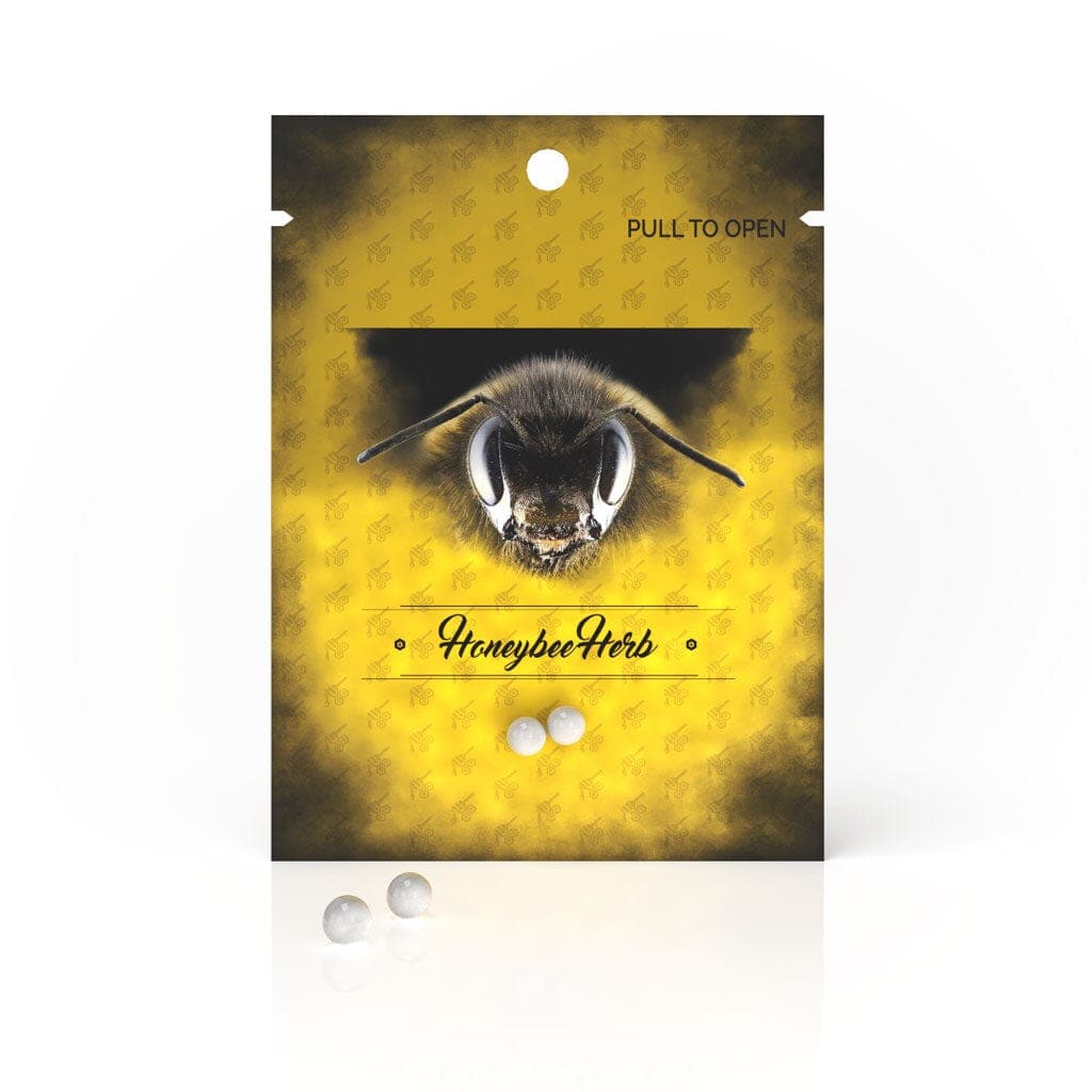 Front view of the Honeybee Herb Honey Pearls packaging, displaying a golden, reflective design with a pull-to-open tab.