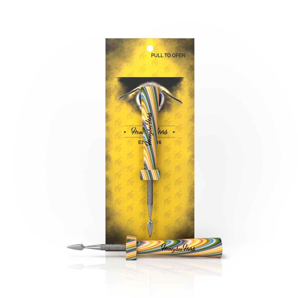 Front view of the HoneyStick Classic Resin Dab Tool, packaged in a patterned sleeve with a pull tab for opening.