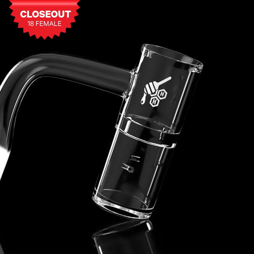 A close-up, angled view of the HONEY WELL QUARTZ BANGER - 90° DEGREE YL, showcasing its clear quartz construction.