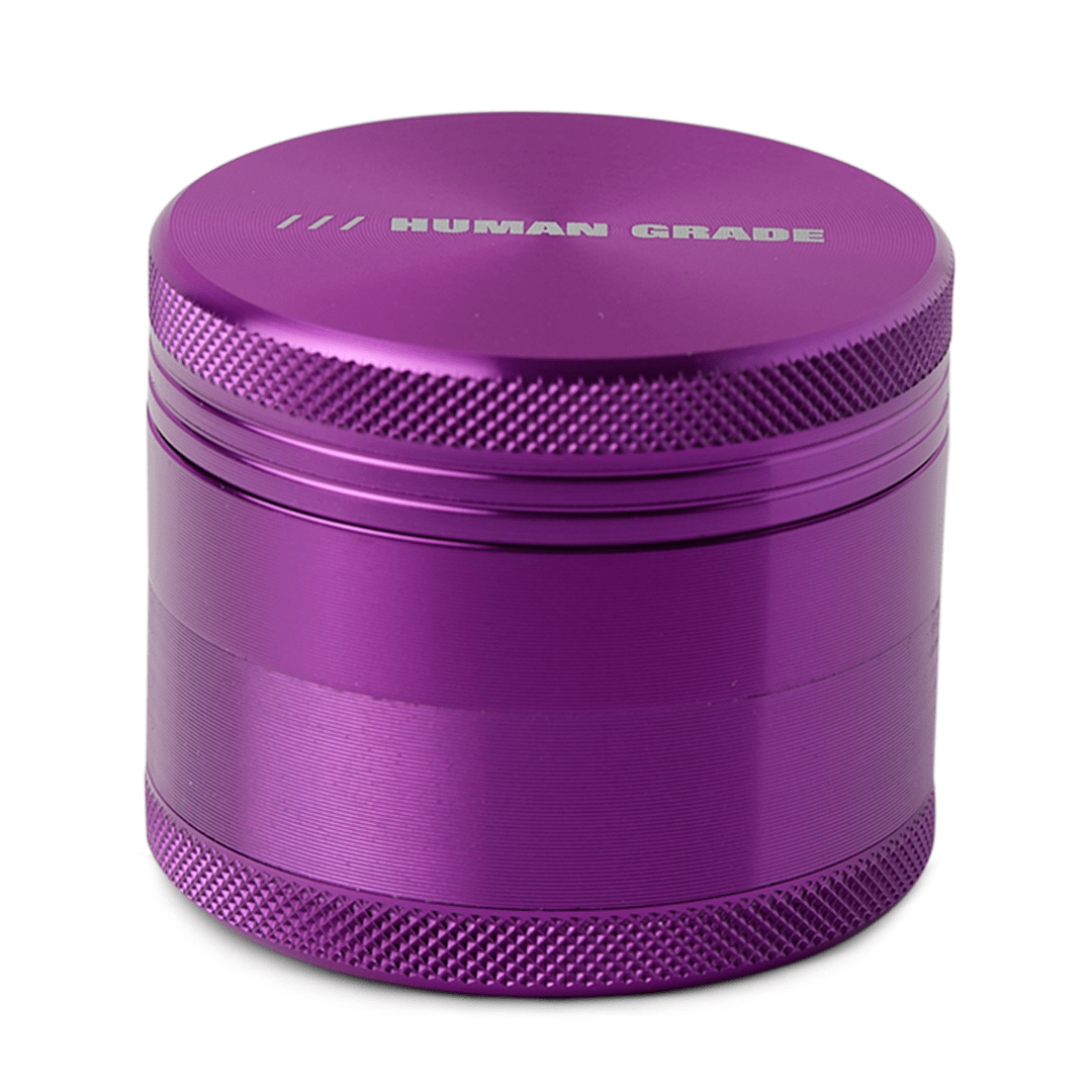 Front view of the Human Grade Grinder 1A (2") featuring a metallic purple, four-piece design with a textured surface.