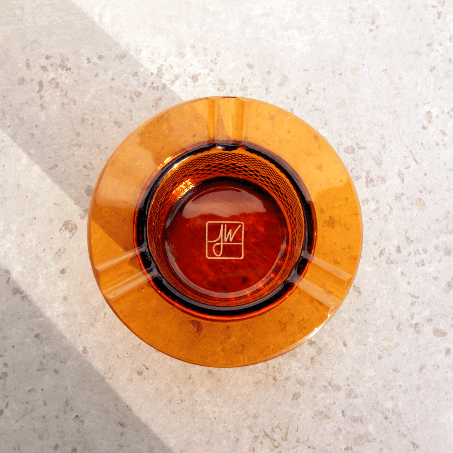 Overhead view of the Jane West Twenties Collection Ashtray, showcasing its circular shape and reflective interior on a light surface.