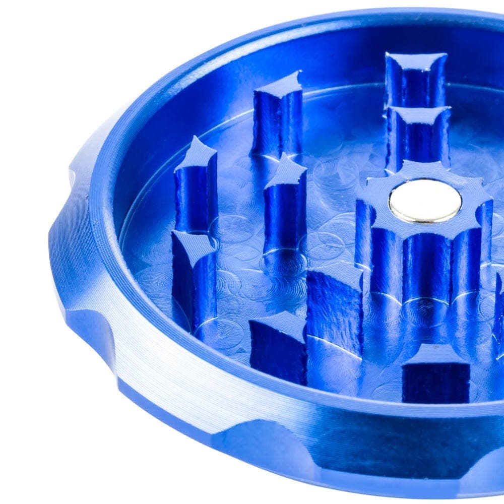 A top-down view of the Bluntman Grinder, revealing a circular interior with multiple metallic grinding teeth.