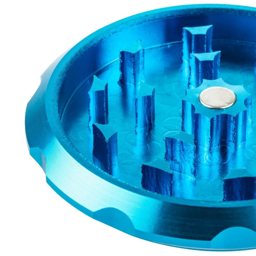 Close-up view of the Buddy Christ Grinder’s internal grinding teeth, highlighting its metallic blue finish and circular design.