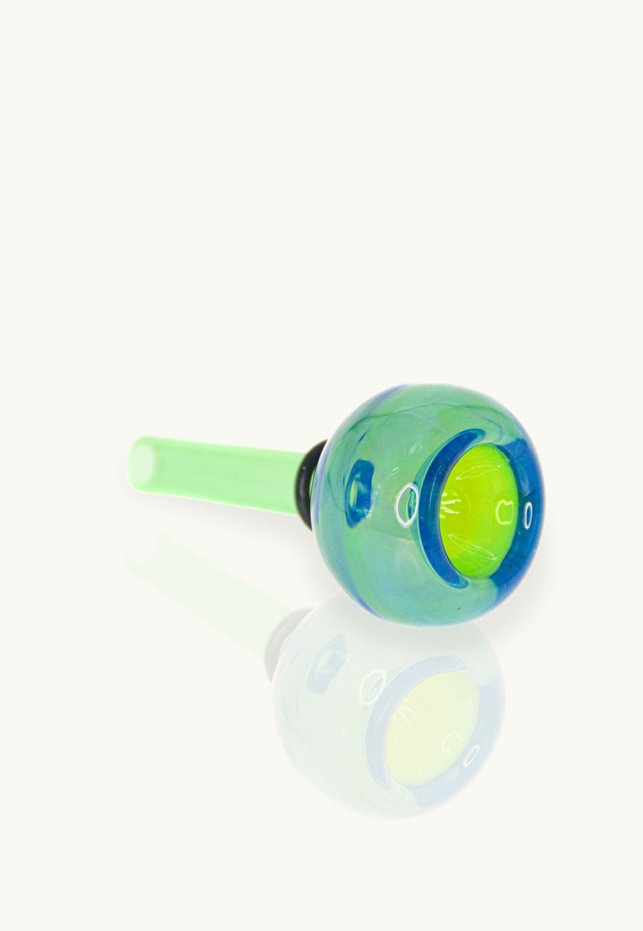 Close-up of the Mermaid Bowl, a vibrant green glass piece with a smooth, rounded shape and visible joint.
