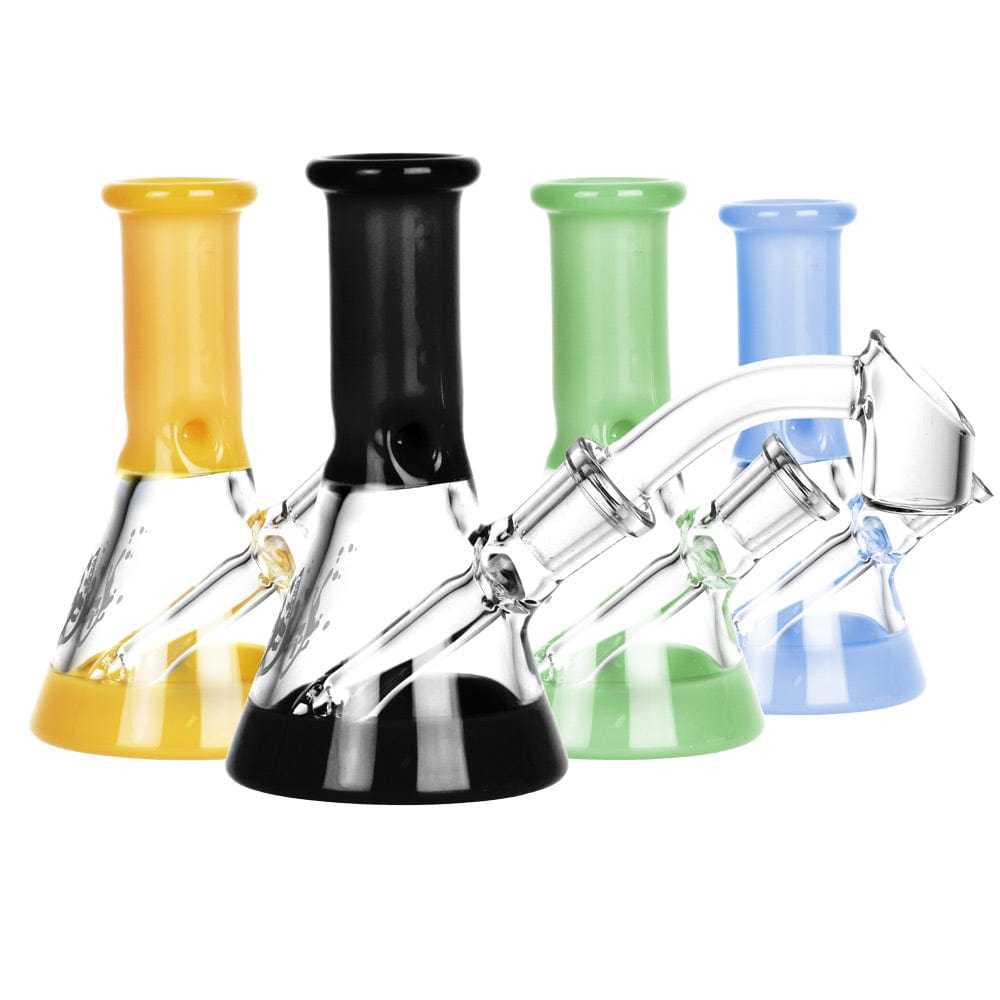 A comparison shot of the Pulsar Mini Bi-Color Beaker Dab Rig in varying shades of colored glass, displayed at a slight angle.