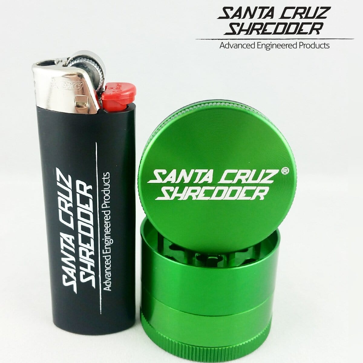 A close-up, angled shot of the Santa Cruz Shredder 4 Piece Mini Grinder, a silver metal grinder resting on a white surface.