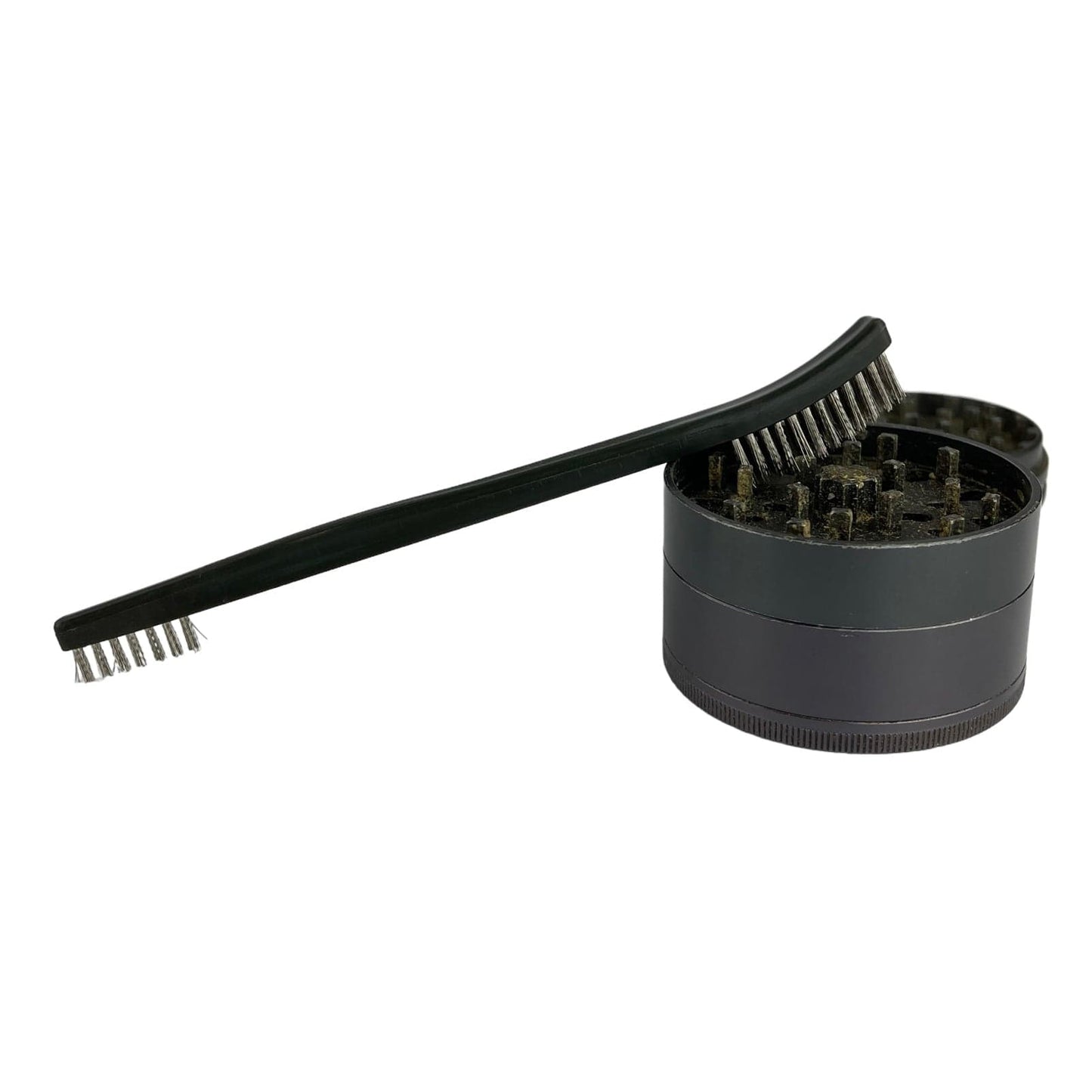 The Grinder Brush appears in a close-up shot, showcasing its dark bristles and cylindrical handle against a plain white background.