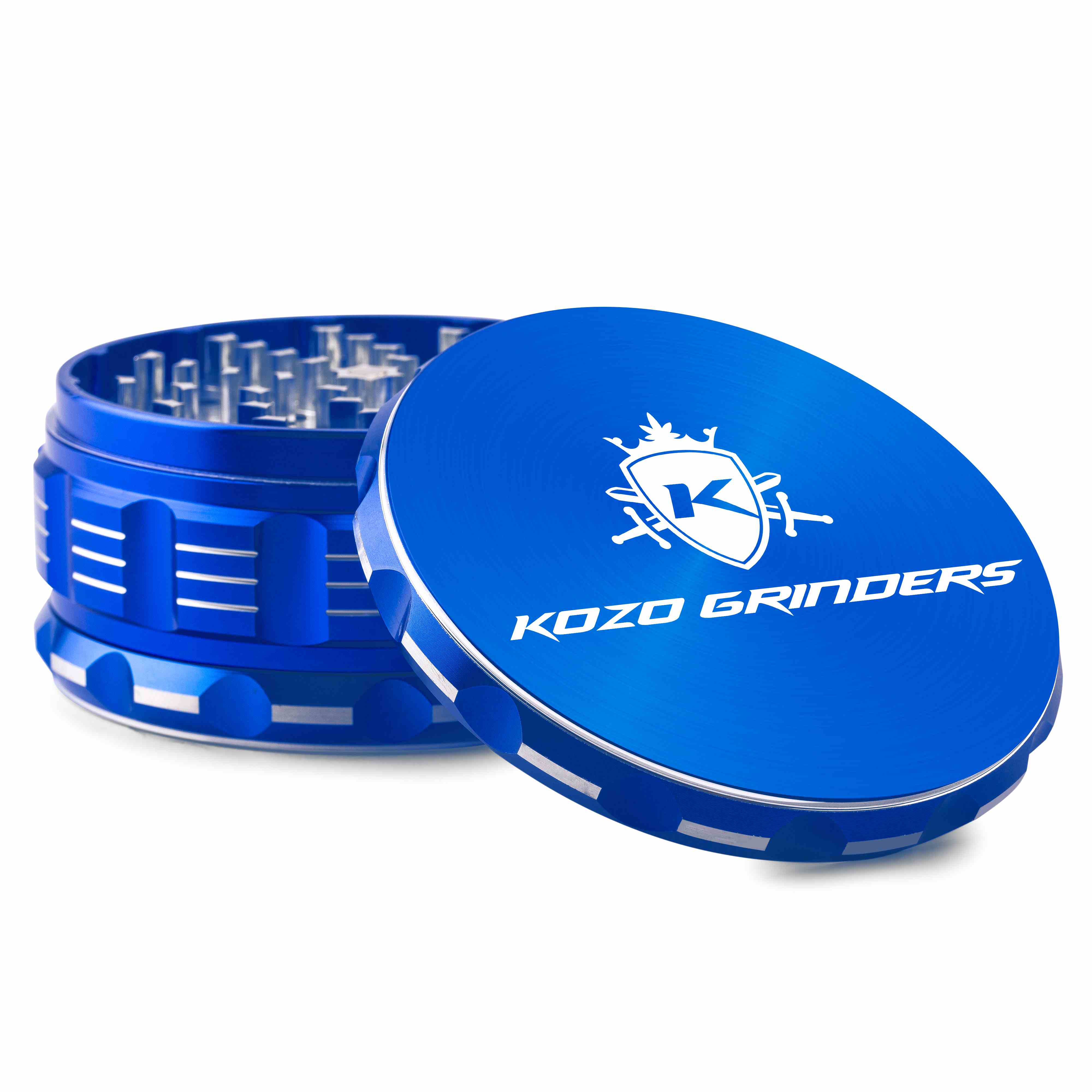 Close-up angled view of the bright blue Kozo Grinder 4" showing the textured lid with logo and exposed metal teeth inside.