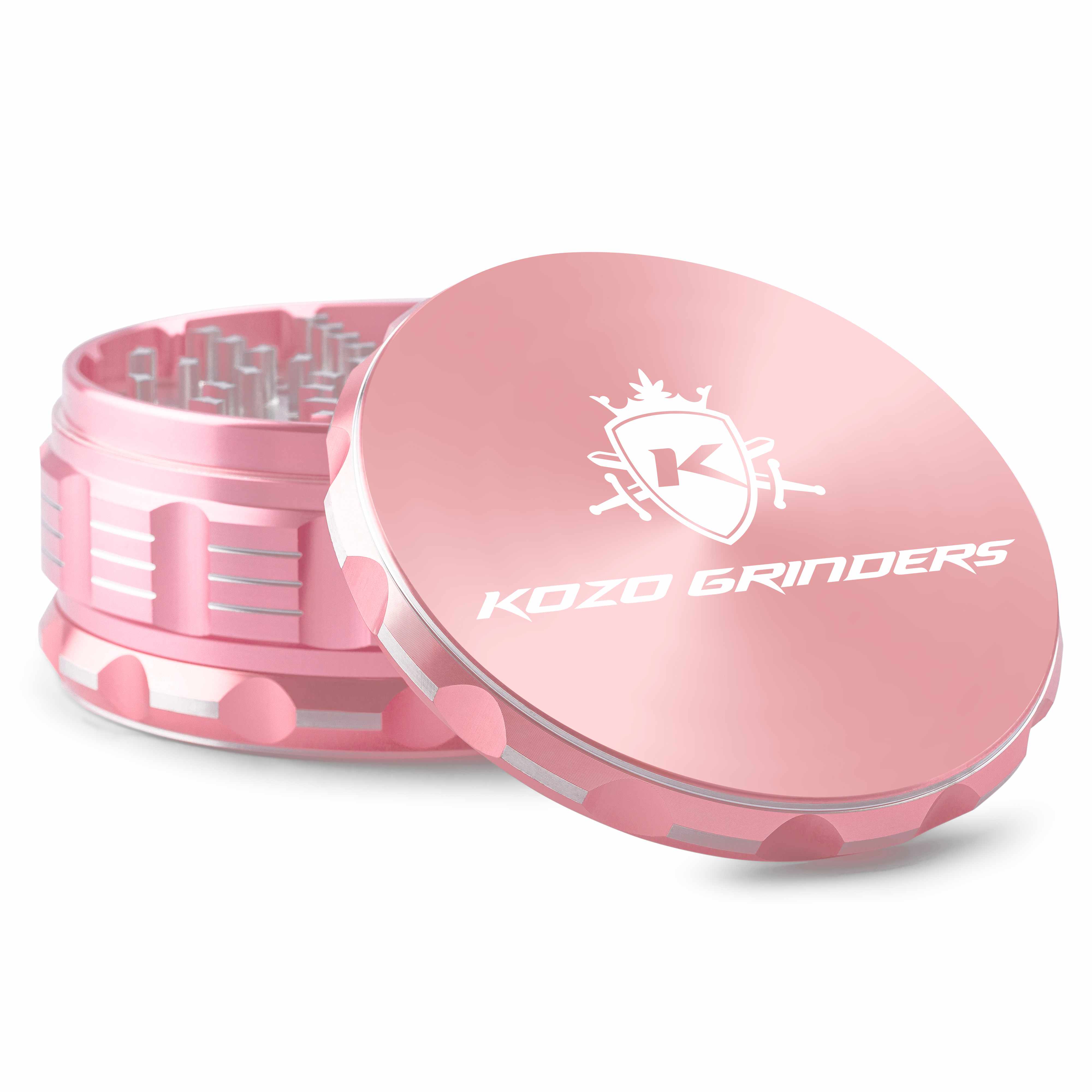 Close-up angled view of the pink Kozo Grinder 4" showing the open top teeth and glossy lid with white logo.