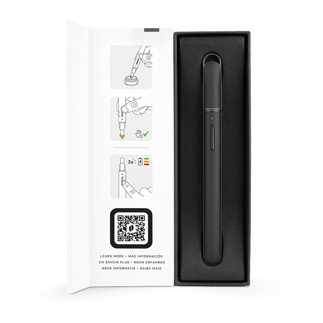 Top-down view of the black Puffco New Hot Knife nestled in its foam tray beside an open white instruction panel with illustrated steps and a QR code.