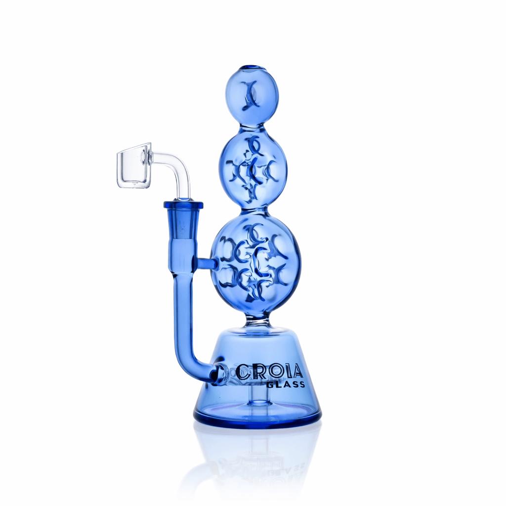 Studio-lit front view of the Croia Glass 8" Triple Stack Swiss Perc Recycler Dab Rig | Croia Glass in translucent blue, showing its three stacked spherical chambers and side joint.